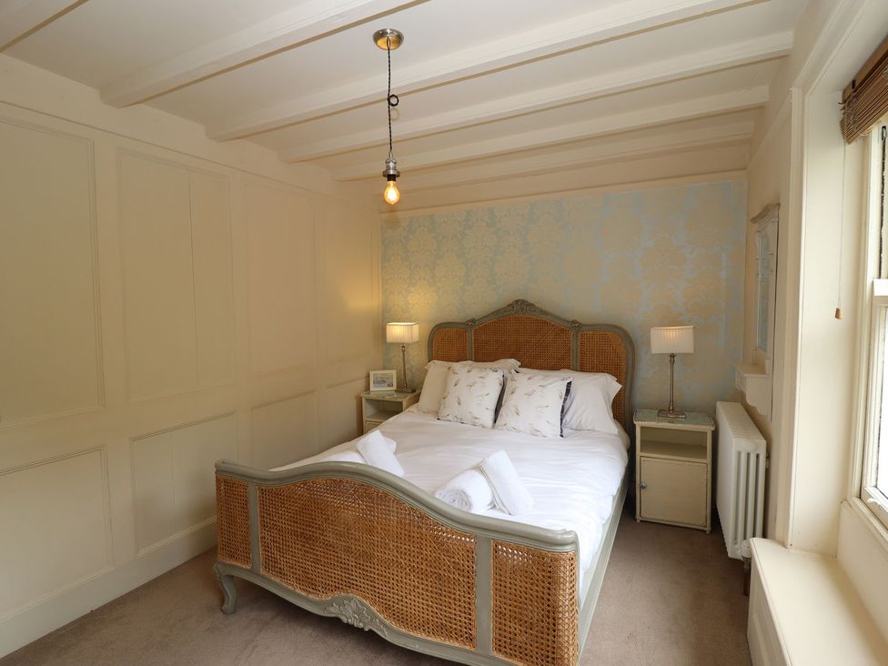 A bedroom with a bed and bedside table at Greenfingers in Whitby