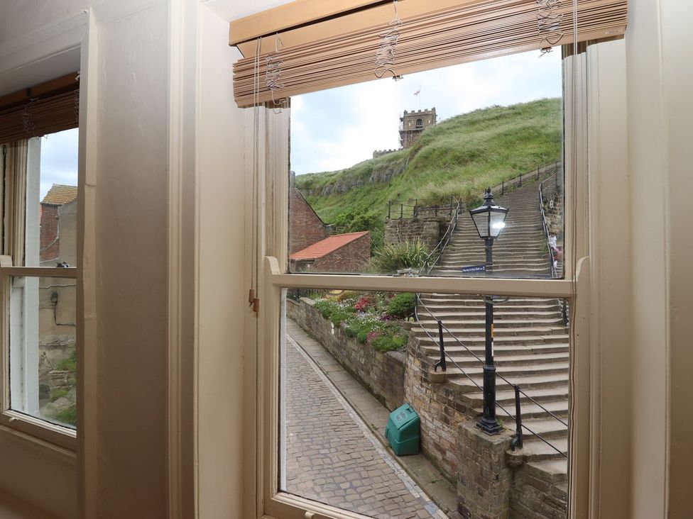 A view from a window showing street and stairs at Greenfingers in Whitby