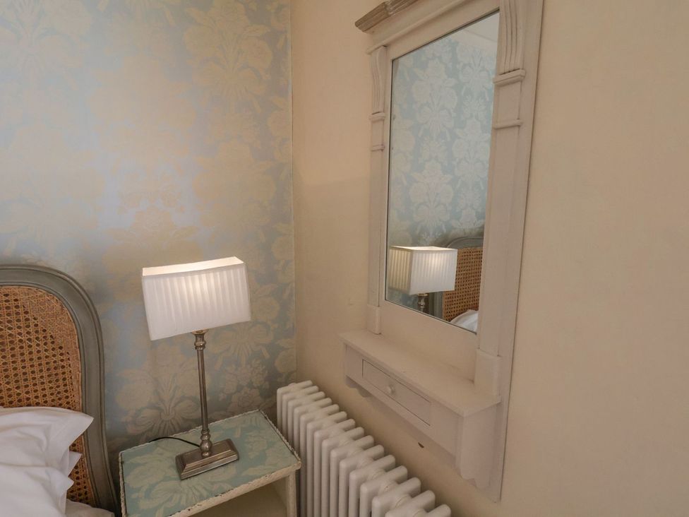 A bedroom with a bed and a lamp at Greenfingers in Whitby