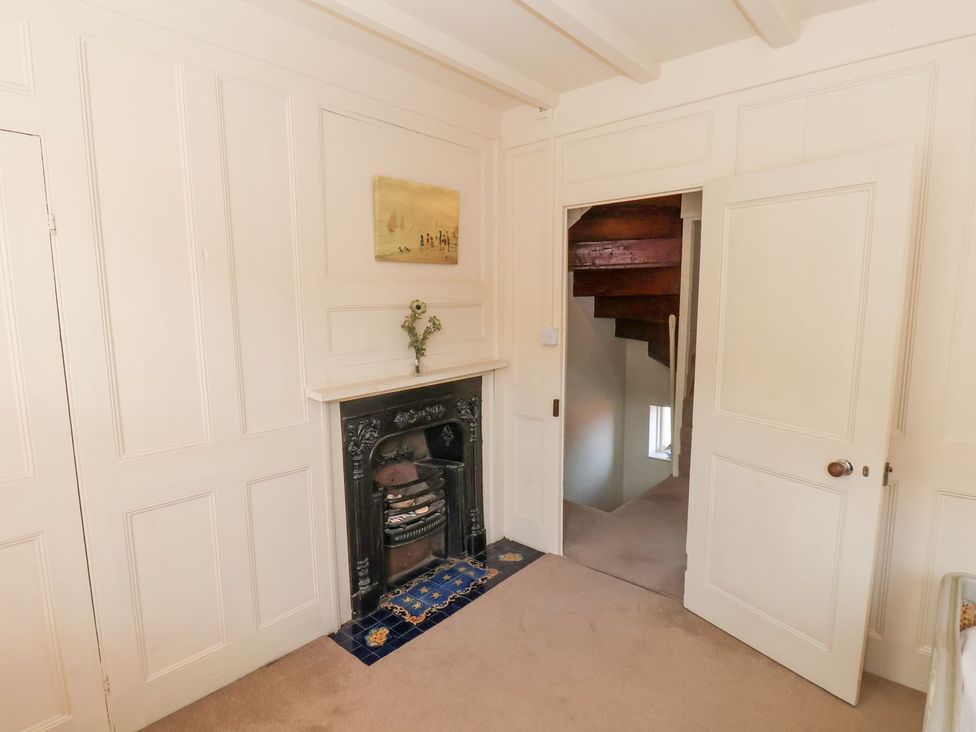 A room with a fireplace and a staircase at Greenfingers in Whitby