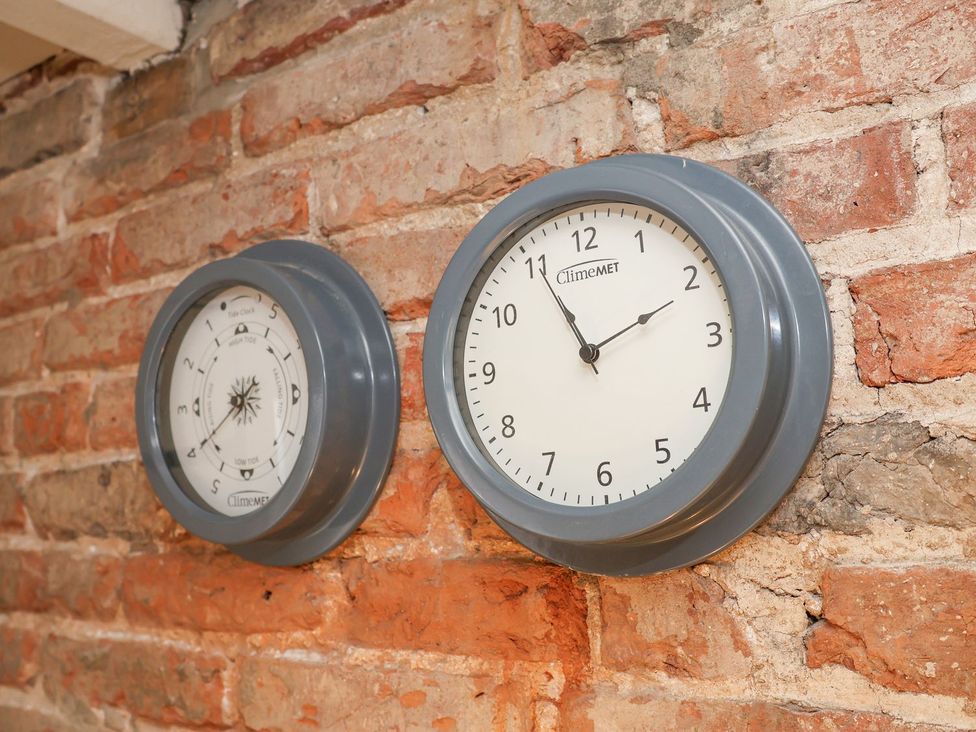 Two clocks on a brick wall at Greenfingers Whitby