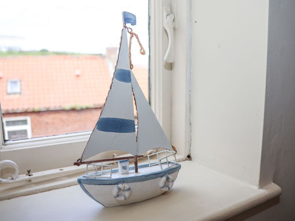 A sailboat decoration on a windowsill at Greenfingers in Whitby