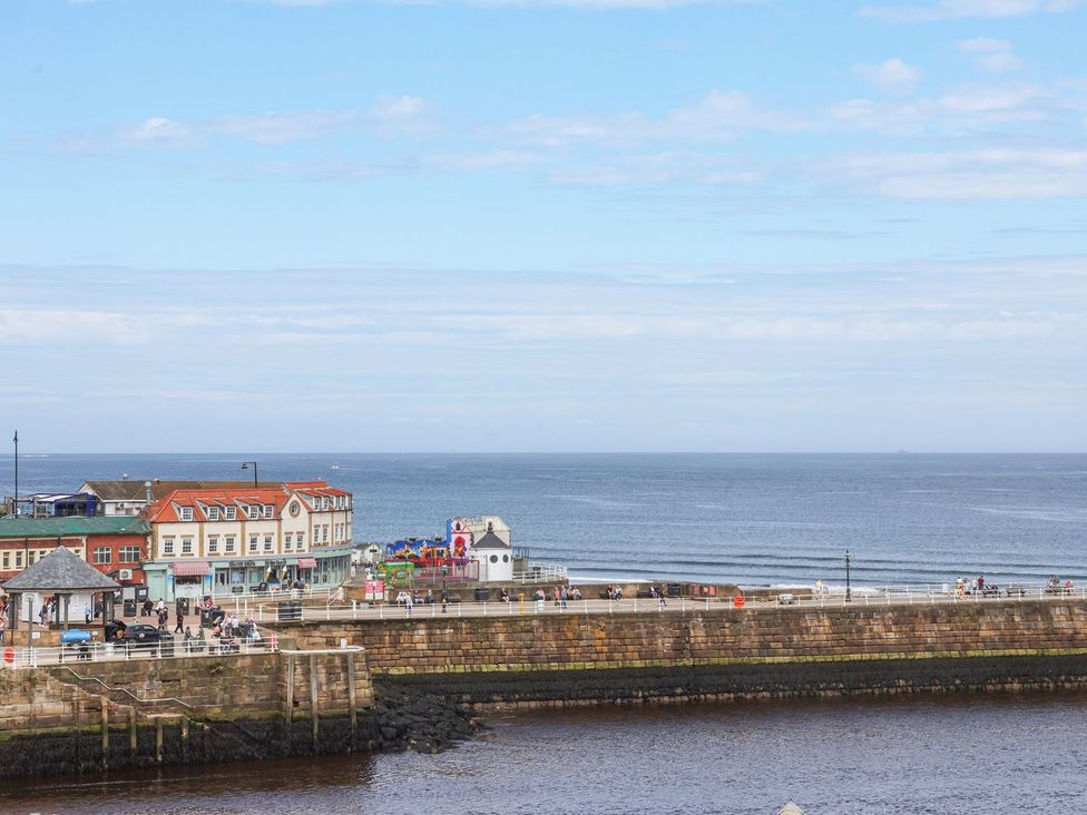 A view of buildings and the ocean at Greenfingers in Whitby