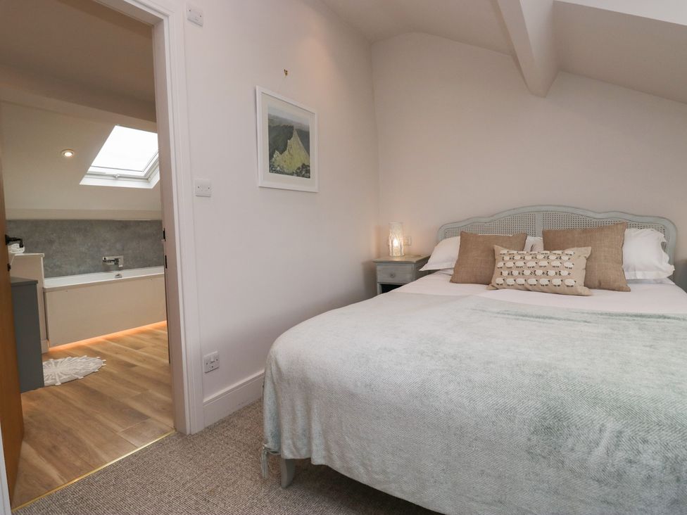 A bedroom with a bed and attached bathroom at Wansfell Nook in Ambleside
