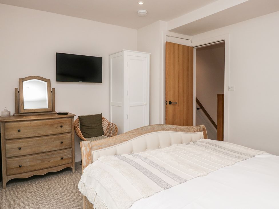 A bedroom with a bed, dresser, and television at Wansfell Nook in Ambleside