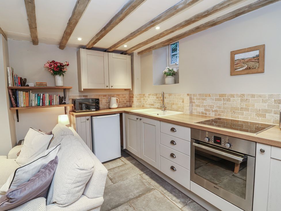 A kitchen with storage, appliances and a worktop at Woodedge in Porlock