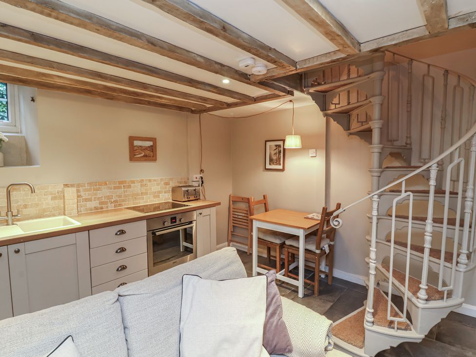 A kitchen with a sink and stove at Woodedge in Porlock