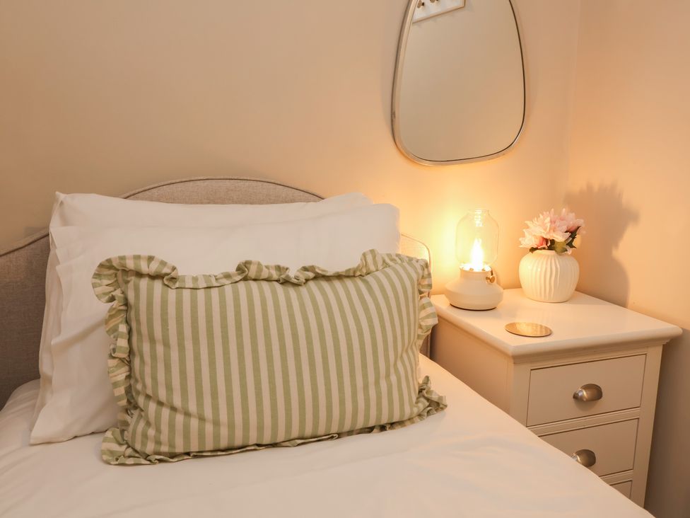 A bedroom with a bed and a bedside table at Woodedge in Porlock