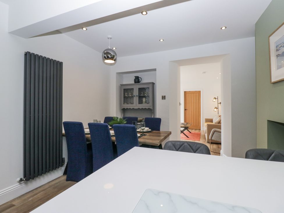A dining room with a table and chairs at Holy Trinity Cottage in Millom