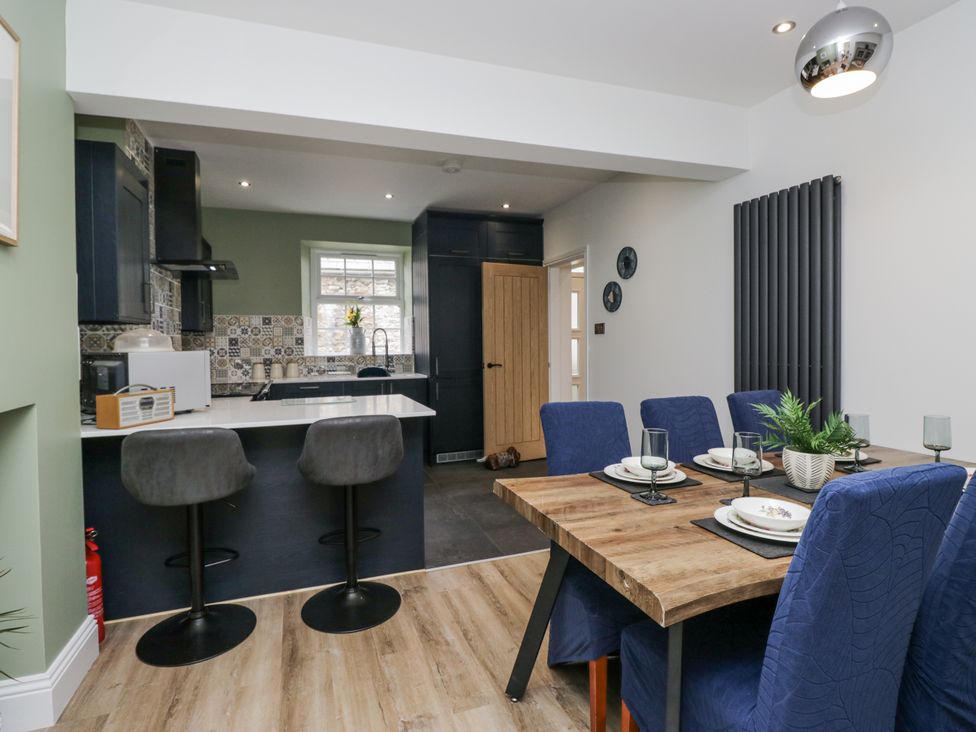 A dining room with a table and chairs at Holy Trinity Cottage in Millom