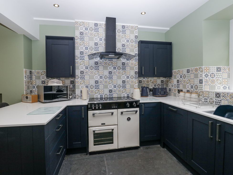 A kitchen with an oven and microwave at Holy Trinity Cottage in Millom