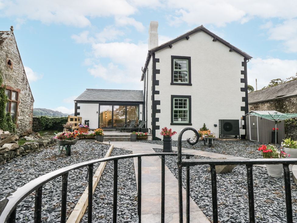 A house with a garden and flower pots at Holy Trinity Cottage in Millom