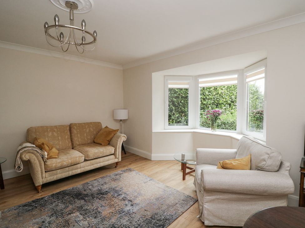 A living room with a sofa and armchair at 7 Belfort Court 