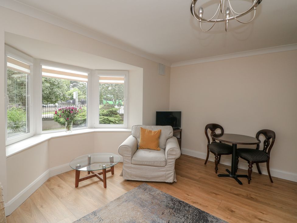 A living room with seating and a table at 7 Belfort Court