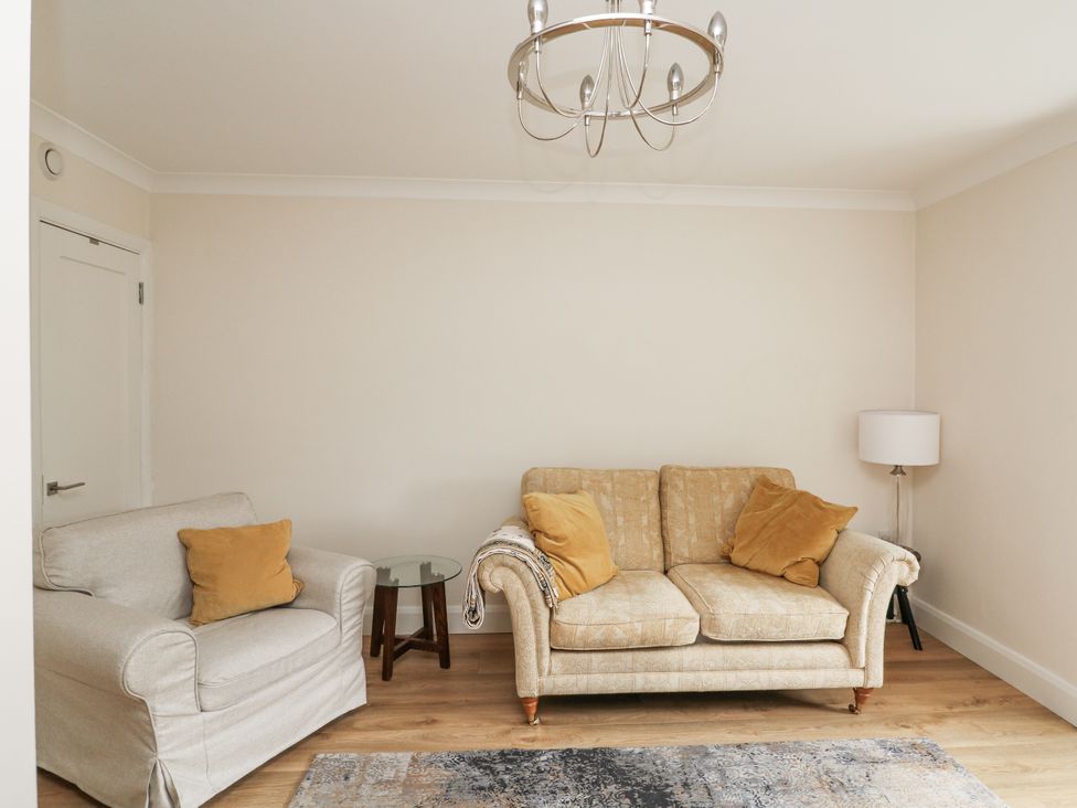 A living room with a sofa and armchair at 7 Belfort Court