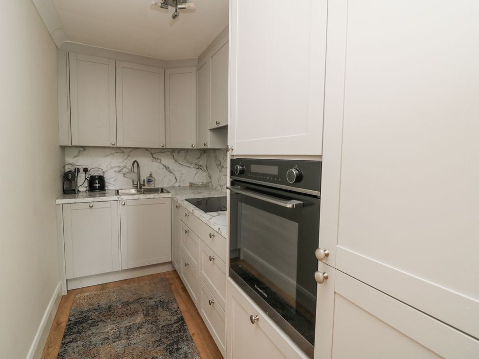 A kitchen with cabinets, sink and oven at 7 Belfort Court