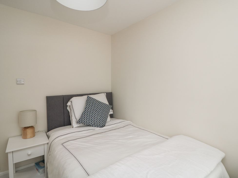 A bedroom with a bed and nightstand at 7 Belfort Court 