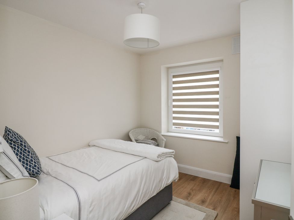 A bedroom with a bed and window at 7 Belfort Court
