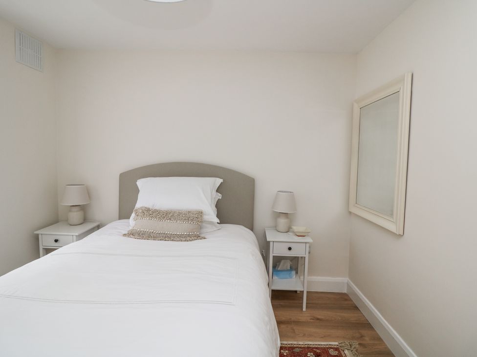 A bedroom with a bed and nightstand at 7 Belfort Court 