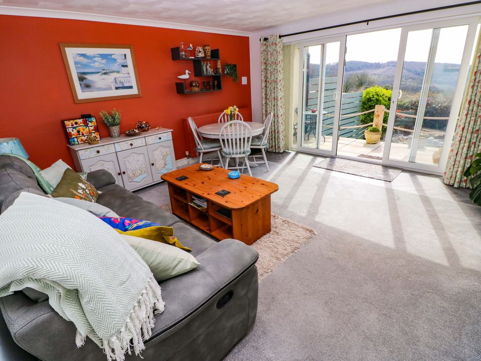 A living room with a sofa and coffee table at No.51 Llanteg Park in Amroth