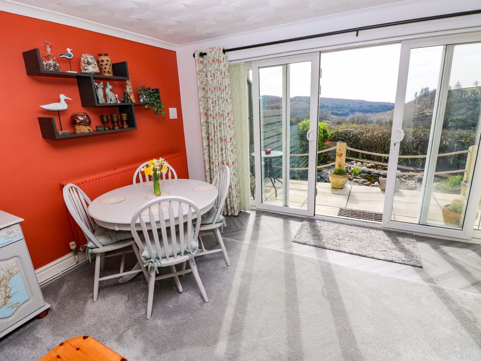 A dining room with a table and chairs at No.51 Llanteg Park Amroth