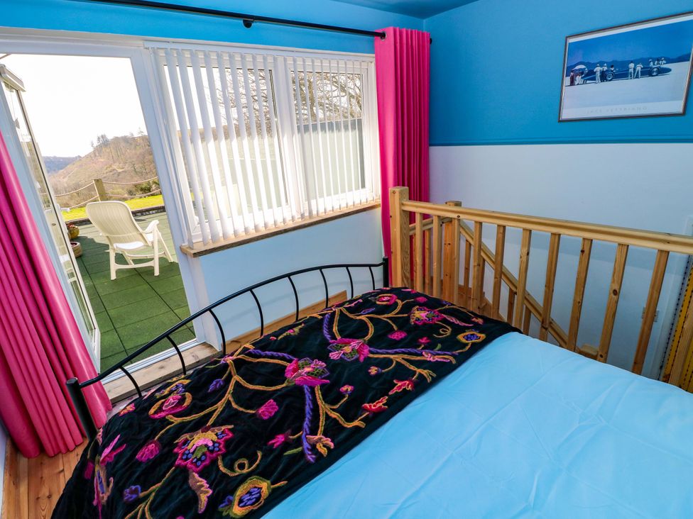 A bedroom with a bed and window at No.51 Llanteg Park Amroth