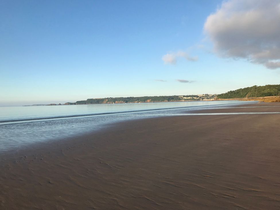 A beach with sand and water at No.51 Llanteg Park Amroth