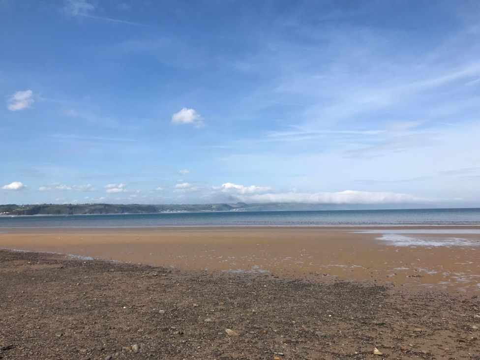 A beach with sand and ocean at No.51 Llanteg Park in Amroth
