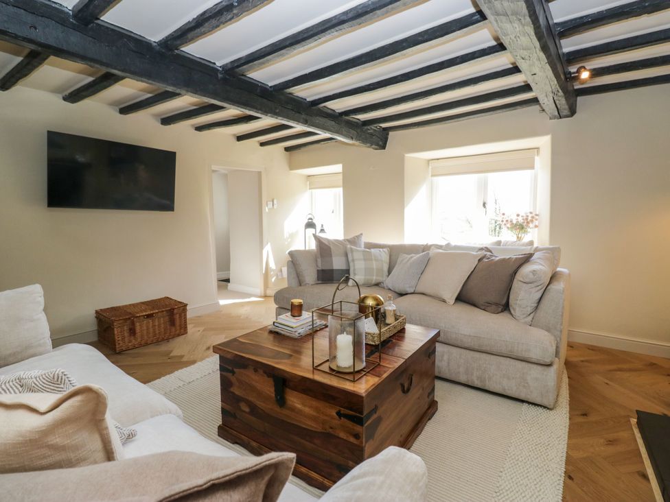 A living room with a sofa and coffee table at Barn Howe Lyth near Levens