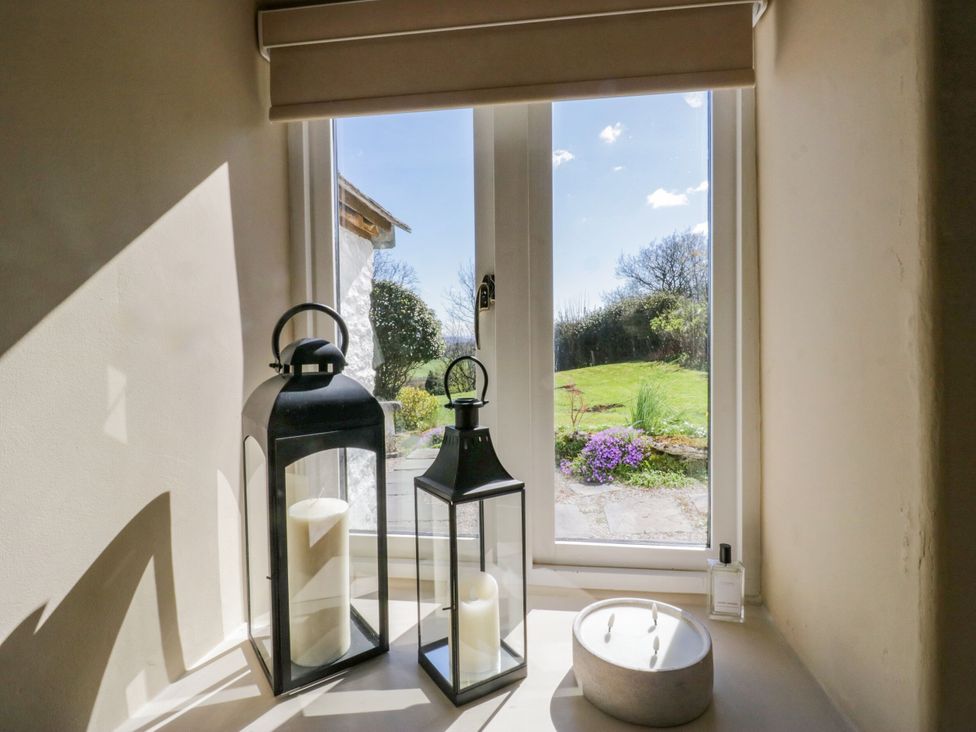Interior with lanterns and view of garden at Barn Howe in Lyth near Levens