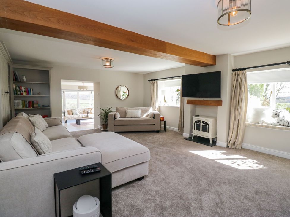 A living room with a sofa and television at Barn Howe Lyth near Levens