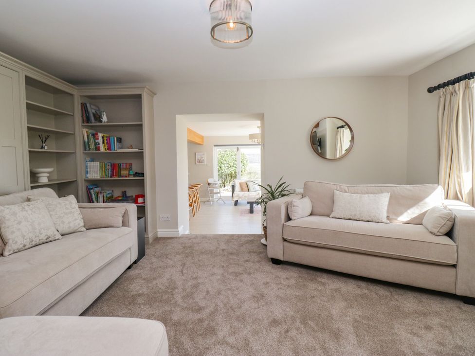 A living room with a sofa and bookshelf at Barn Howe in Lyth near Levens
