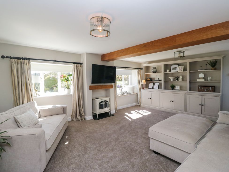 A living room with a sofa and television at Barn Howe Lyth near Levens