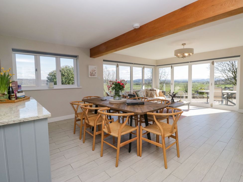 A dining room with a table and chairs at Barn Howe Lyth near Levens