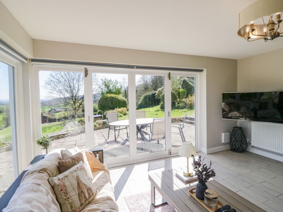 A living room with a sofa and a view of the garden at Barn Howe Lyth near Levens
