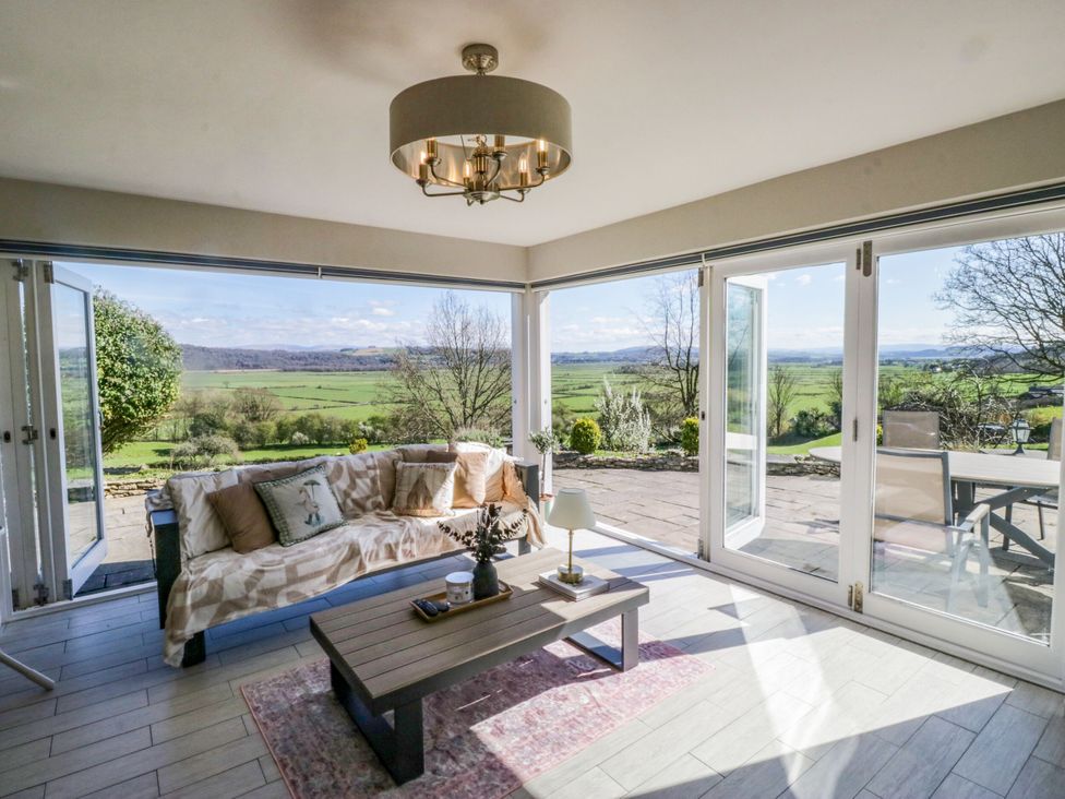 A seating area with a sofa and table at Barn Howe in Lyth near Levens