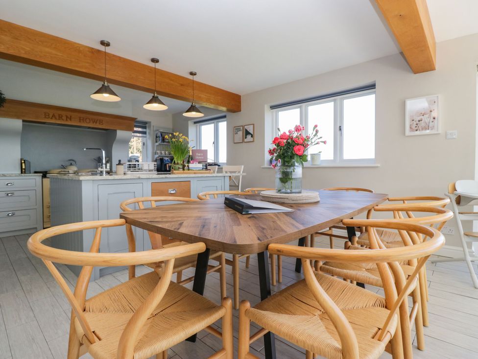 A dining room with a table and chairs at Barn Howe in Lyth near Levens