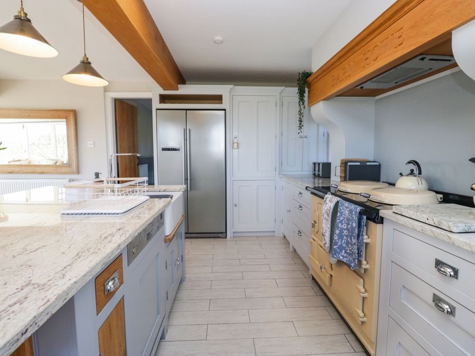 A kitchen with a refrigerator and stove at Barn Howe Lyth near Levens