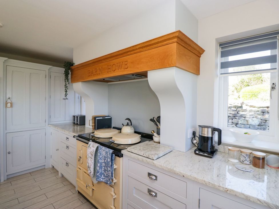 A kitchen with an oven and extractor hood at Barn Howe in Lyth near Levens