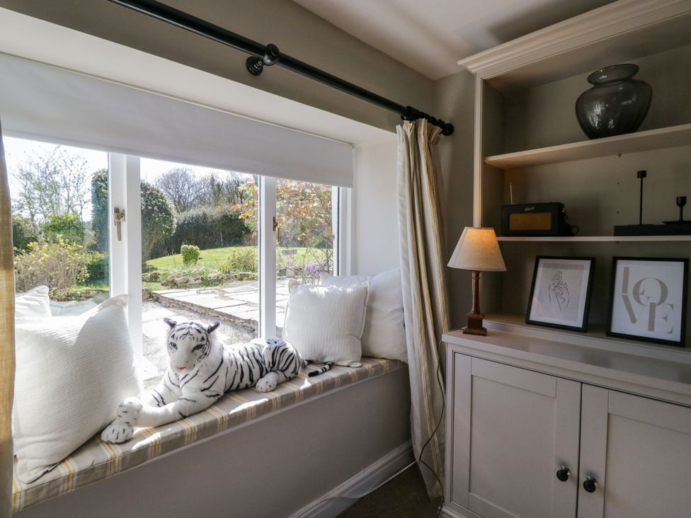 A snug with a window seat and stuffed animal at Barn Howe Lyth near Levens