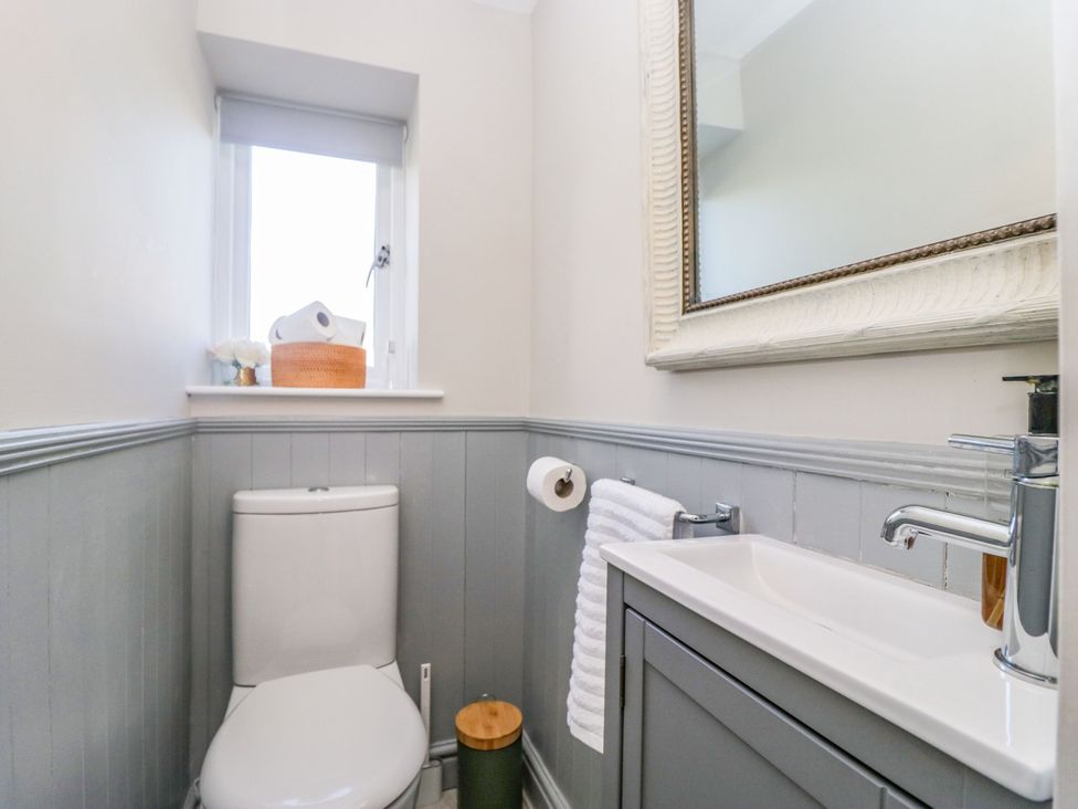 A bathroom with a toilet and sink at Barn Howe Lyth near Levens