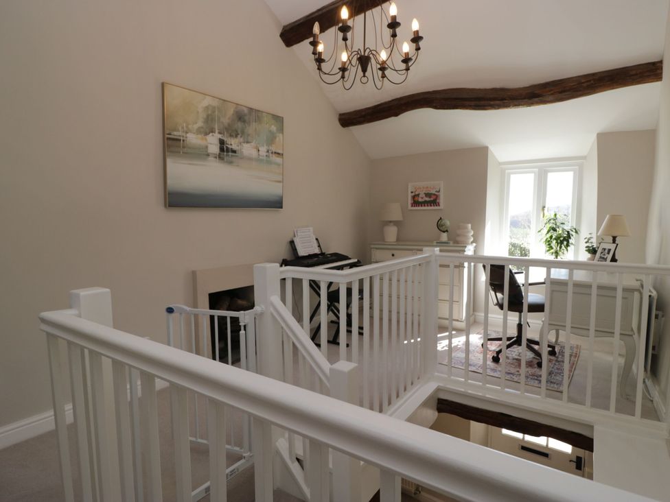 A landing area with a piano and desk at Barn Howe Lyth near Levens