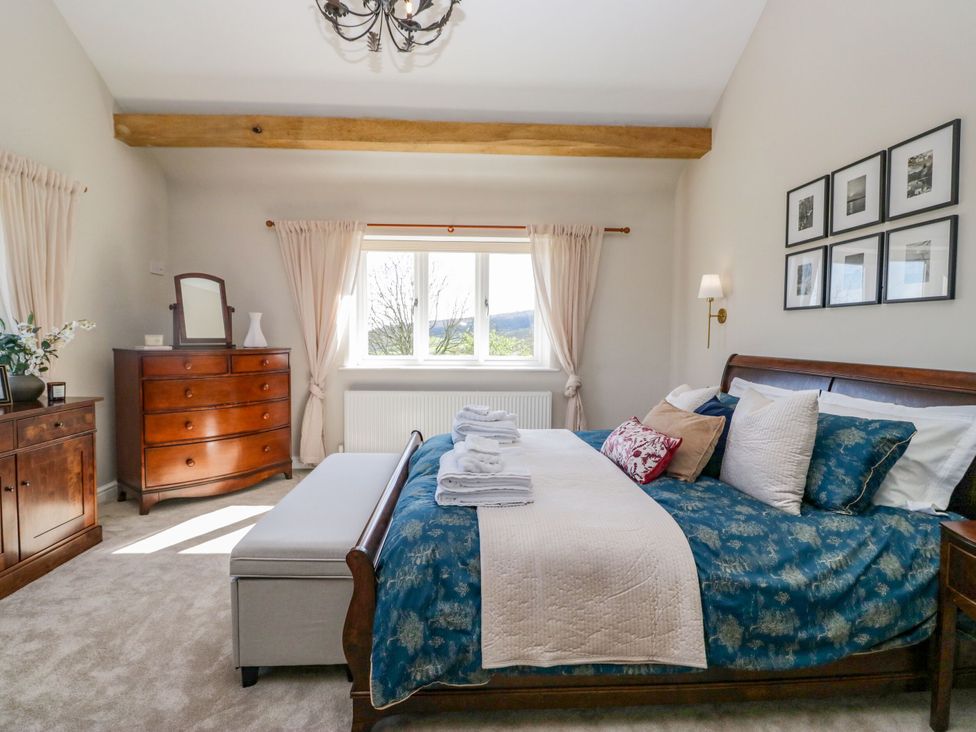 A bedroom with a bed and chest of drawers at Barn Howe Lyth near Levens