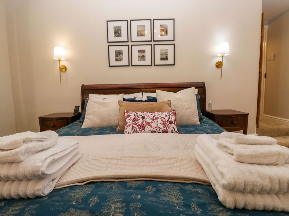 A bedroom with a bed and pillows at Barn Howe Lyth near Levens