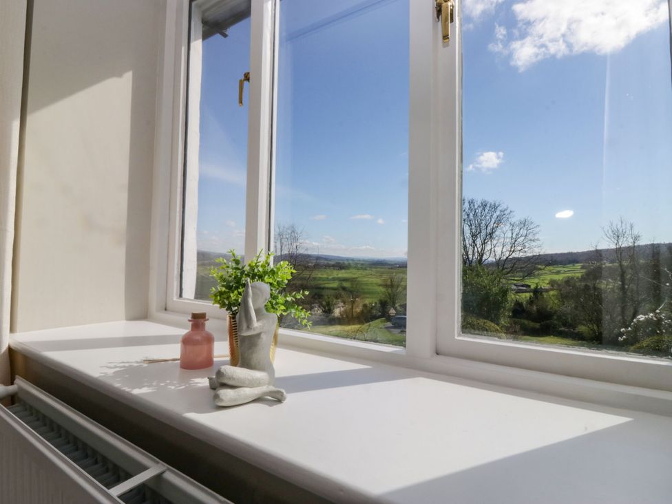 A window with a view and decorative items at Barn Howe in Lyth near Levens