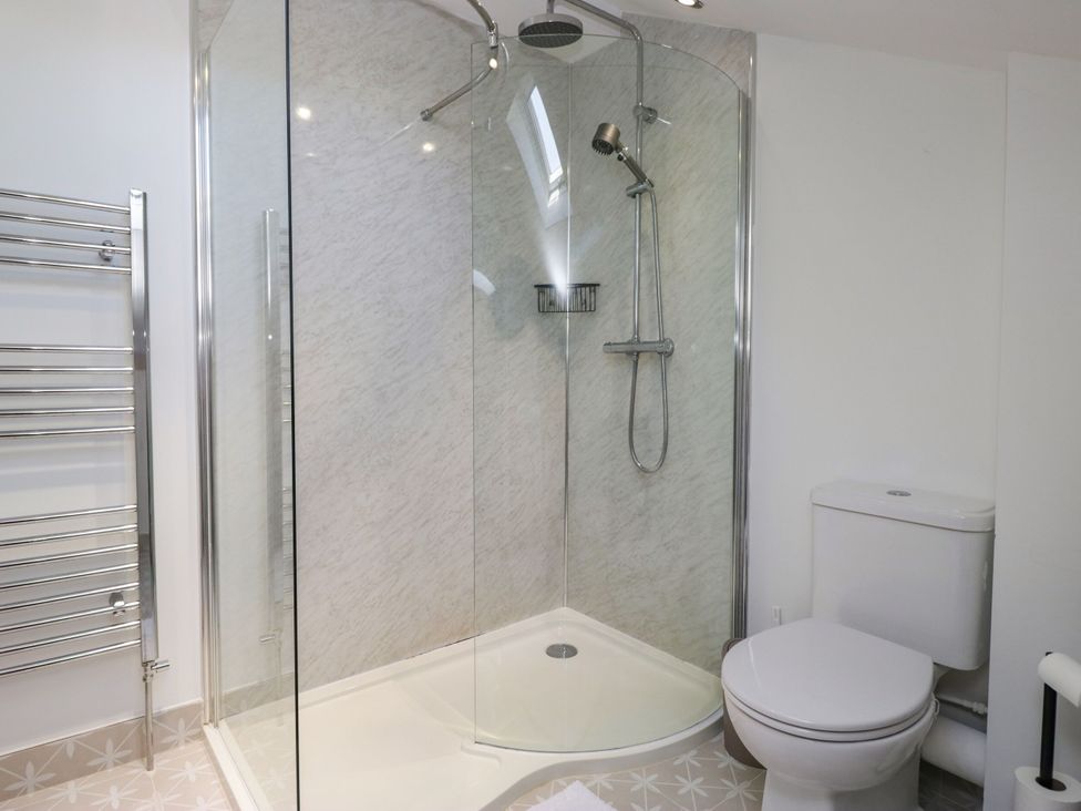 A bathroom with a shower and a toilet at Barn Howe in Lyth near Levens