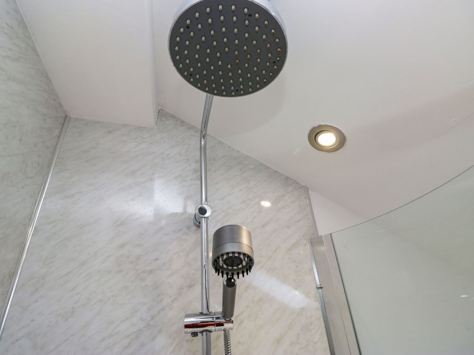 A shower with a rain shower head and a handheld shower at Barn Howe Lyth near Levens