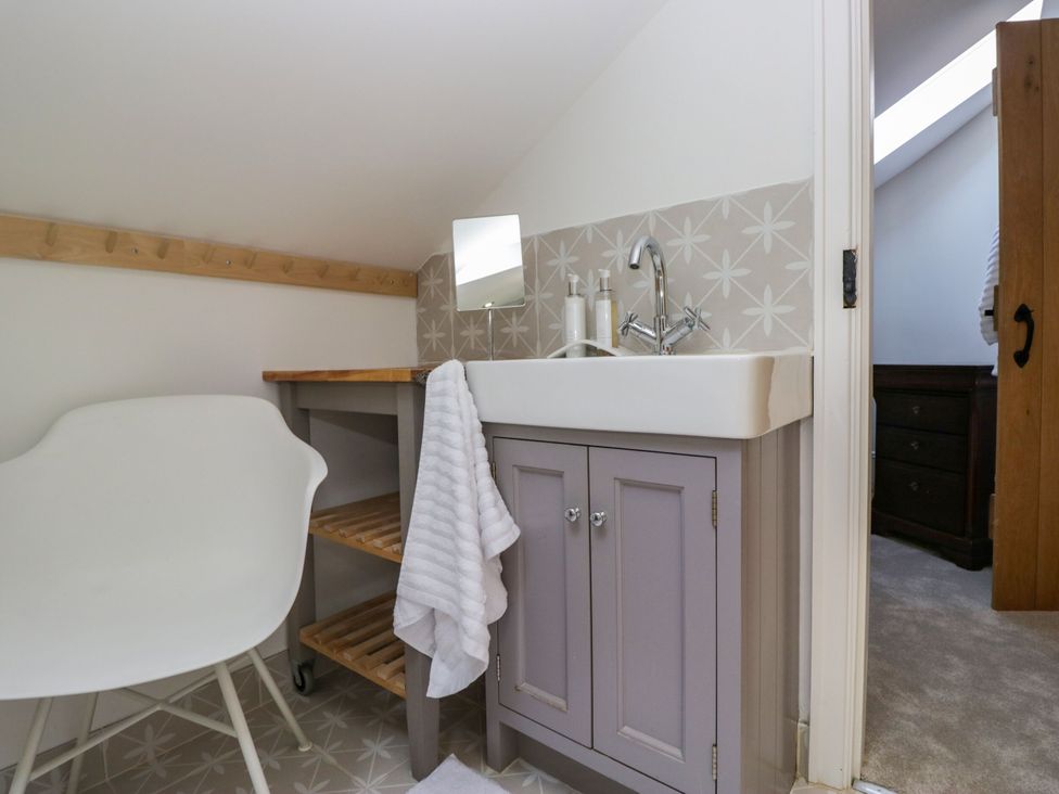 A bathroom with a washbasin and tap at Barn Howe Lyth near Levens