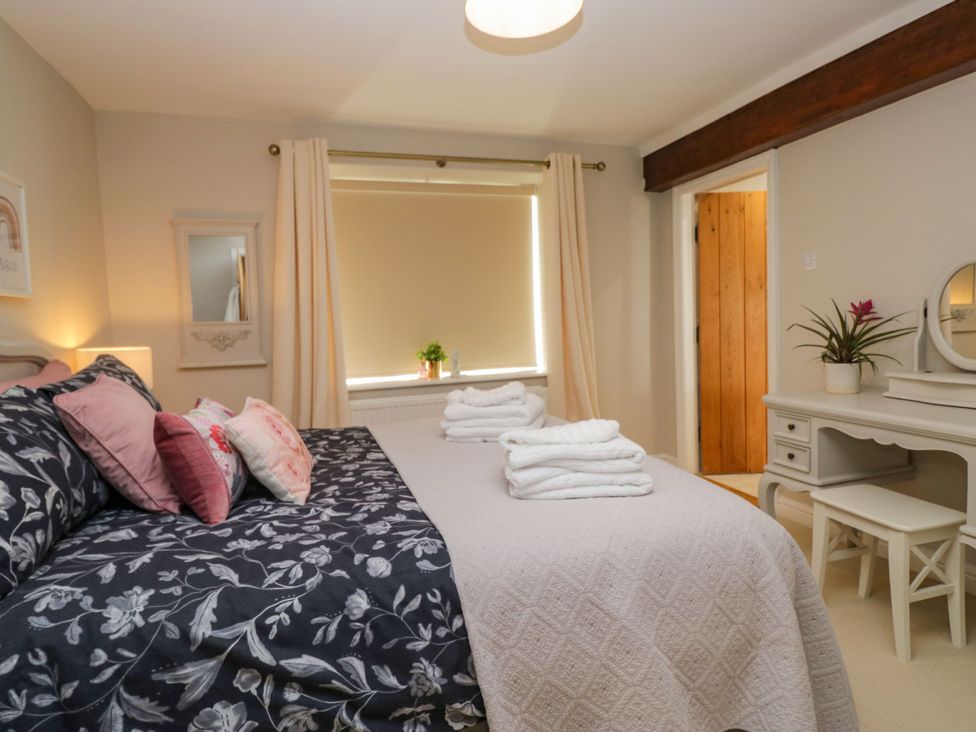 A bedroom with a bed and desk at Barn Howe in Lyth near Levens