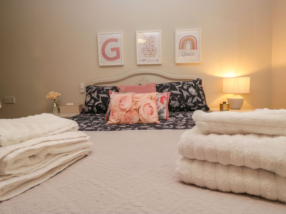 A bedroom with a bed and pillows at Barn Howe in Lyth near Levens